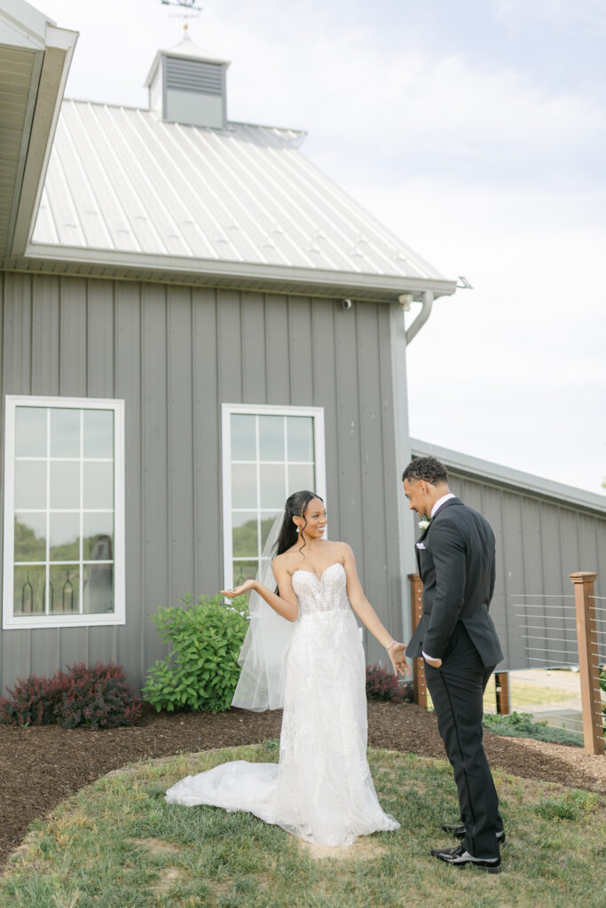 Bride and groom during their first look on the their wedding day at Two Lions Vineyard.